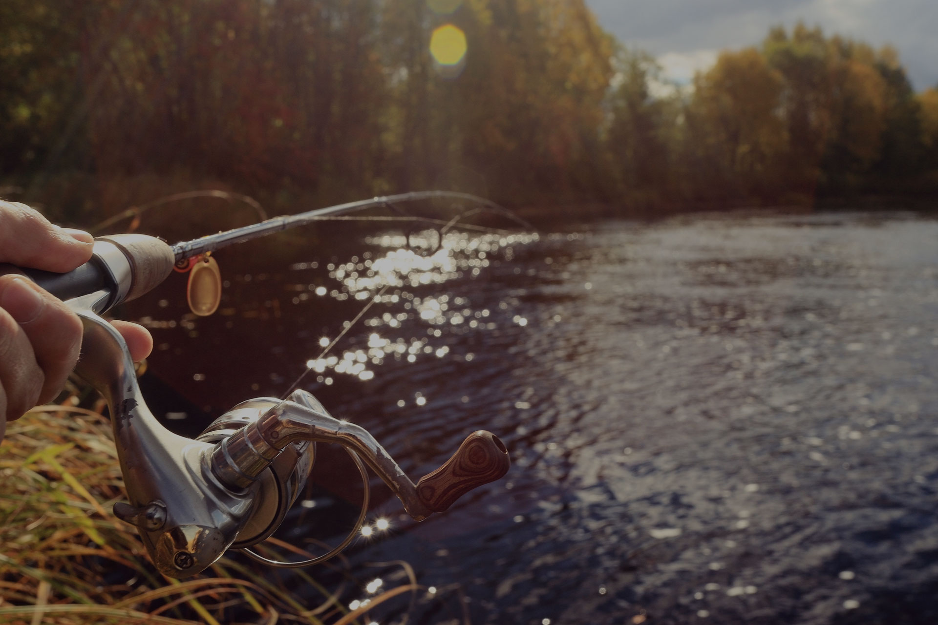 man fishing with fishing rod wheel closeup